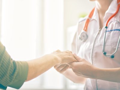 Female patient listening to doctor in medical office.